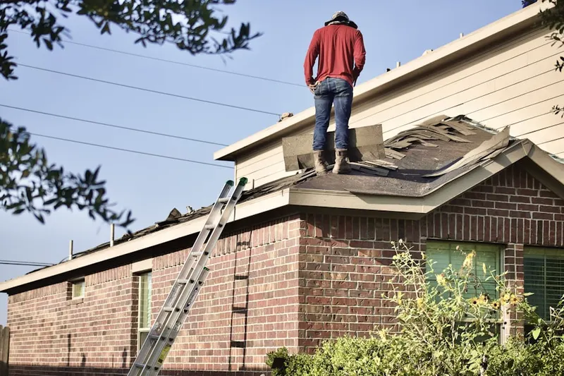 Professional roofer working on a residential roof in Hurline Farms